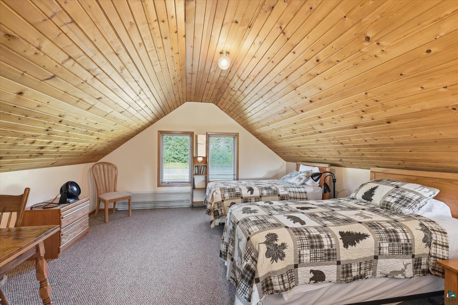 6266 Giants Ridge Road Biwabik, MN 55705 - Photo 28 of 29 Attic room featuring sloped wood-paneled ceilings, two windows, carpeted flooring, and built-in shelving