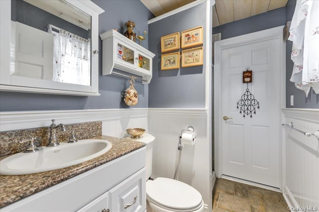 99-78 164th Road Queens, NY 11414 - Photo 14 of 20 a bathroom with a sink toilet and a mirror