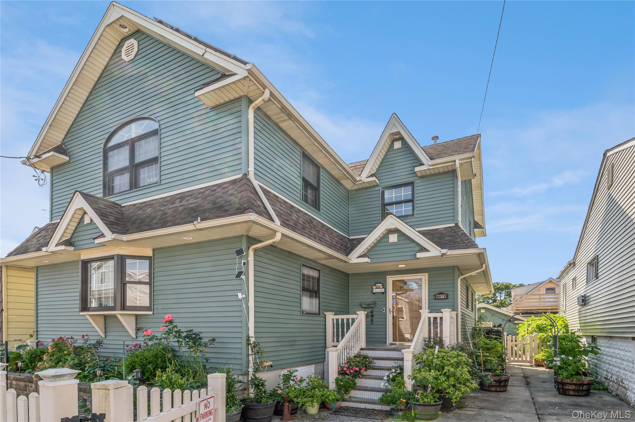 99-78 164th Road Queens, NY 11414 - Photo 2 of 20 a front view of a house with a yard