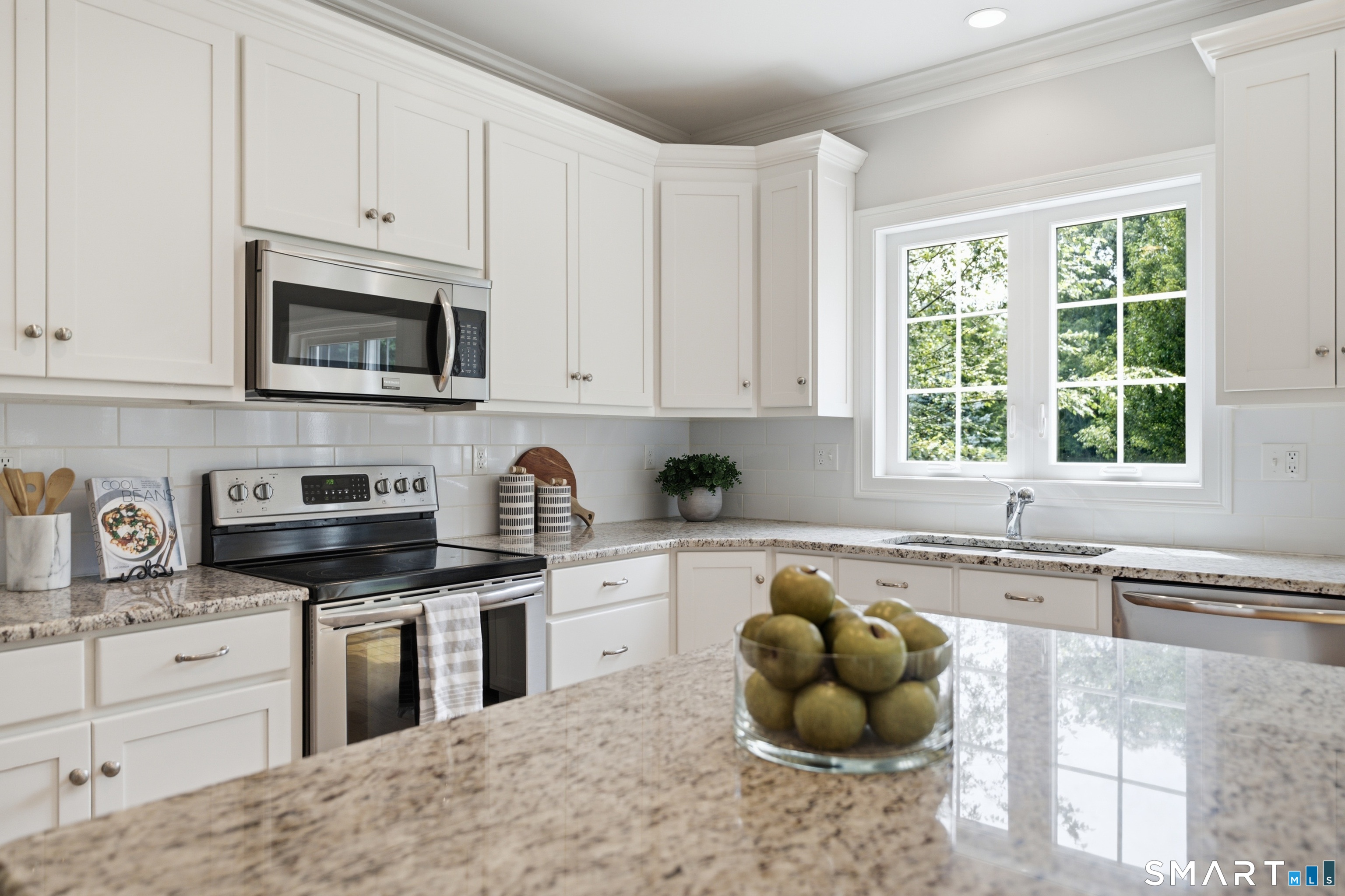 838 Little Meadow Road Guilford, CT 06437 - Photo 10 of 40 The counters are granite, the appliances are Frigidaire Gallery and the backsplash is oversized subway tile.