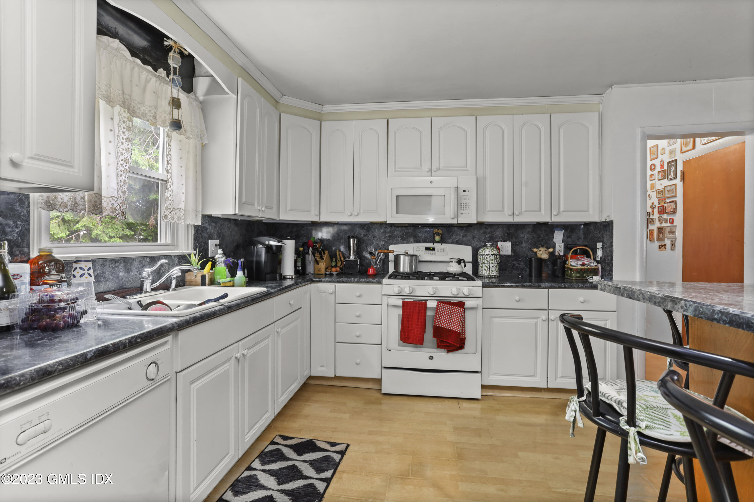 16 Hoover Road Riverside, CT 06878 - Photo 4 of 32 a kitchen with stainless steel appliances granite countertop a stove a sink and white cabinets
