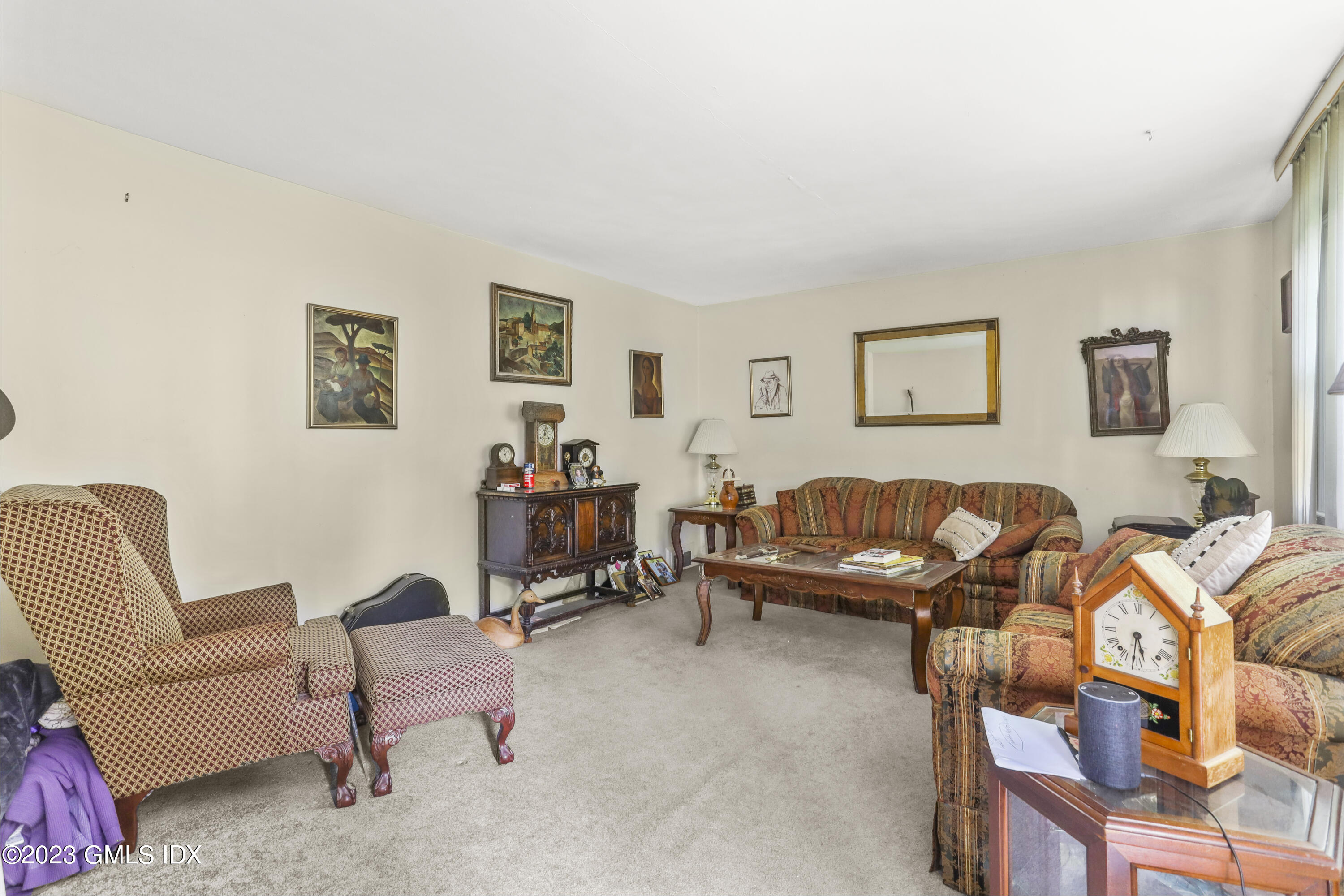 16 Hoover Road Riverside, CT 06878 - Photo 7 of 32 a living room with furniture a couch and paintings on the wall