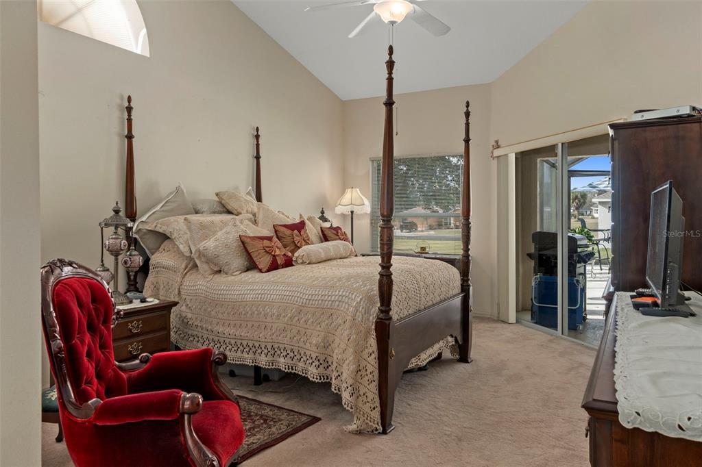 5465 Chestnut Ridge Road Dade City, FL 33523 - Photo 14 of 37 a bedroom with bed couch and window