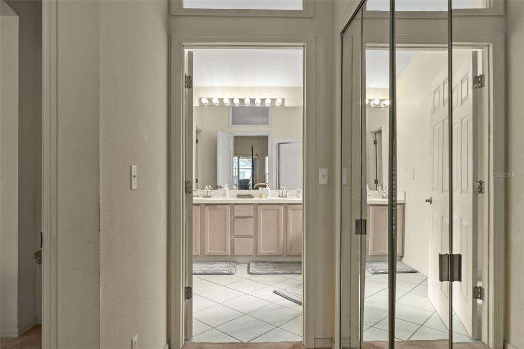 5465 Chestnut Ridge Road Dade City, FL 33523 - Photo 16 of 37 a bathroom with a glass shower door and a mirror