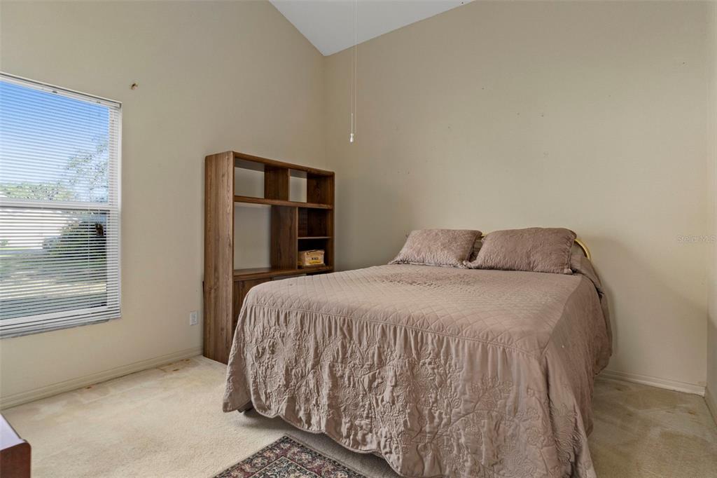 5465 Chestnut Ridge Road Dade City, FL 33523 - Photo 20 of 37 a bedroom with a bed and a window