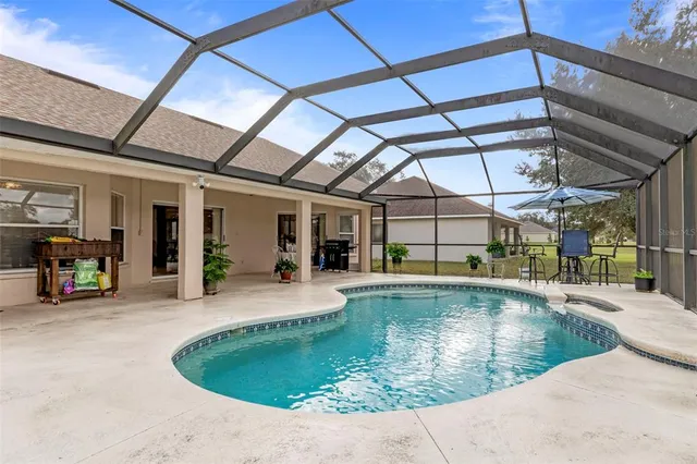 a view of a swimming pool with a patio