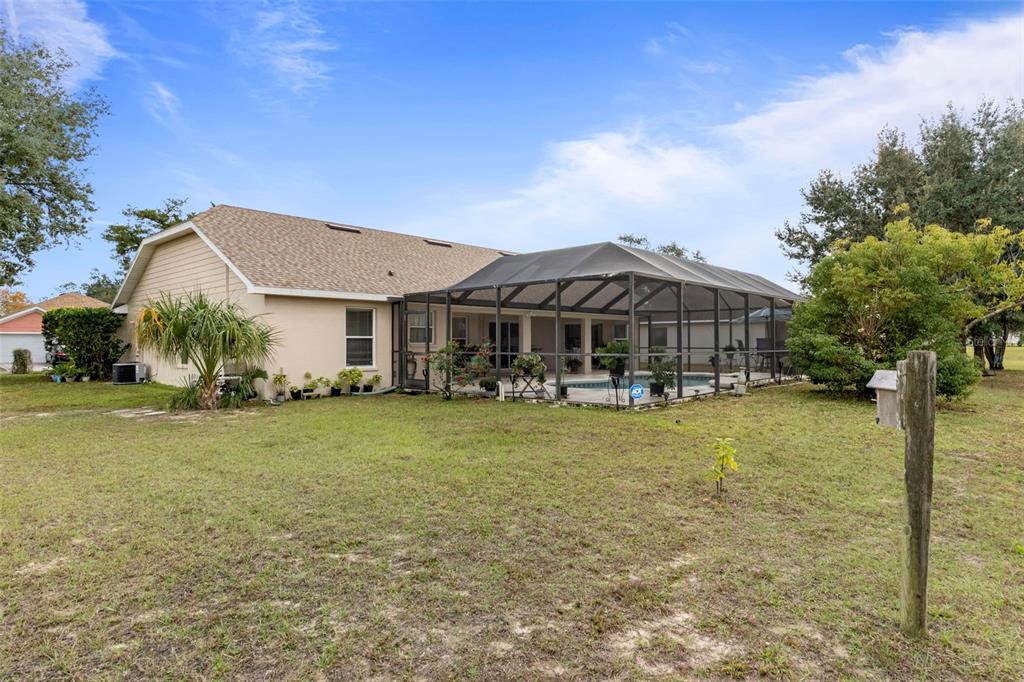 5465 Chestnut Ridge Road Dade City, FL 33523 - Photo 27 of 37 a front view of a house with garden