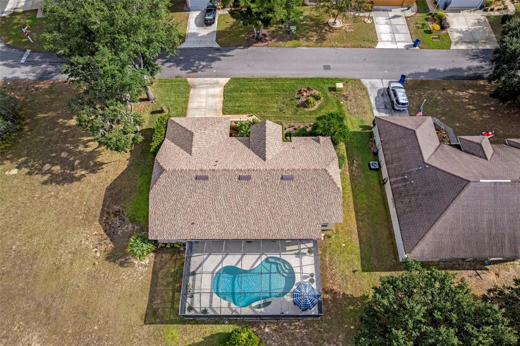5465 Chestnut Ridge Road Dade City, FL 33523 - Photo 29 of 37 an aerial view of a house with yard swimming pool and outdoor seating