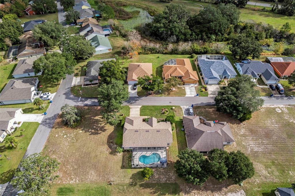 5465 Chestnut Ridge Road Dade City, FL 33523 - Photo 30 of 37 an aerial view of a house with a garden