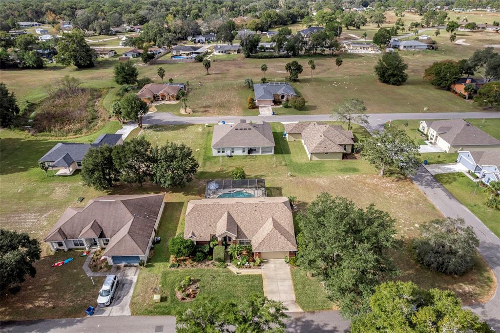 5465 Chestnut Ridge Road Dade City, FL 33523 - Photo 32 of 37 an aerial view of a house with yard and lake view in back
