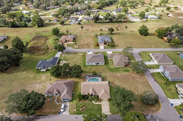 an aerial view of houses with yard