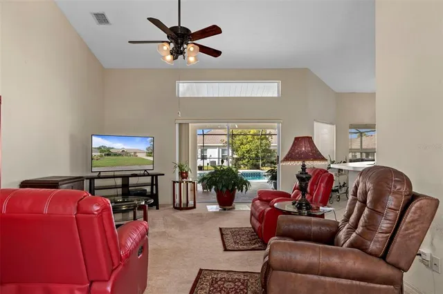a living room with furniture a window and a flat screen tv