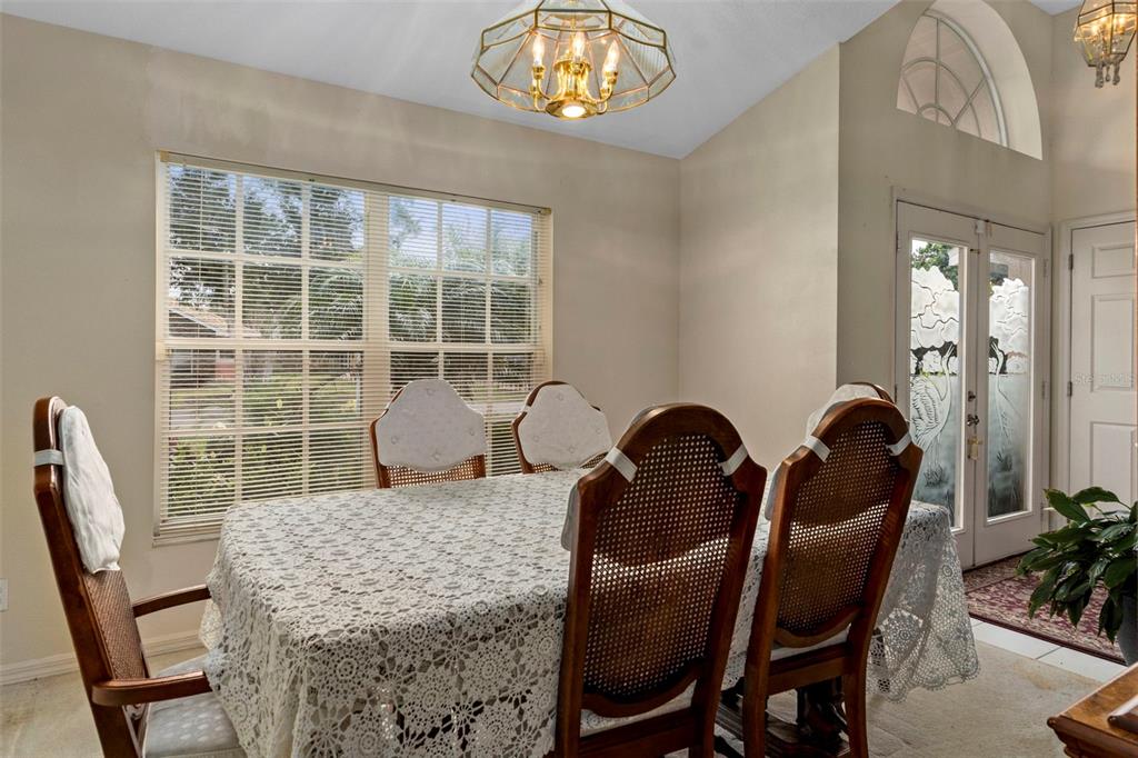 5465 Chestnut Ridge Road Dade City, FL 33523 - Photo 9 of 37 a view of a dining room with furniture and chandelier