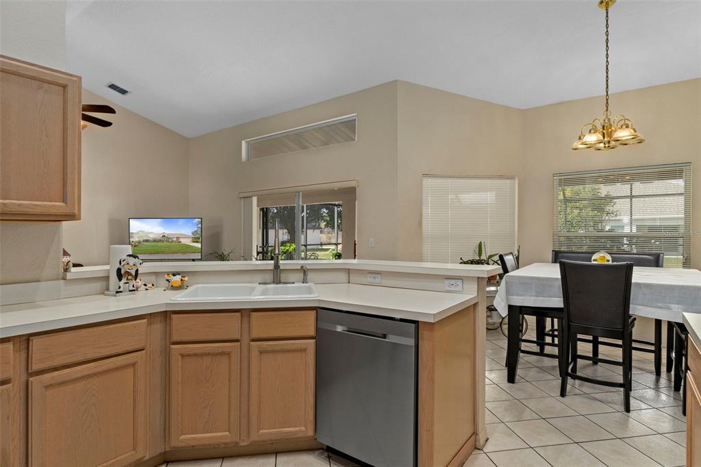 5465 Chestnut Ridge Road Dade City, FL 33523 - Photo 10 of 37 a kitchen with a table chairs sink and cabinets