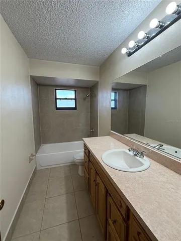 a kitchen with a sink a stove top oven and refrigerator