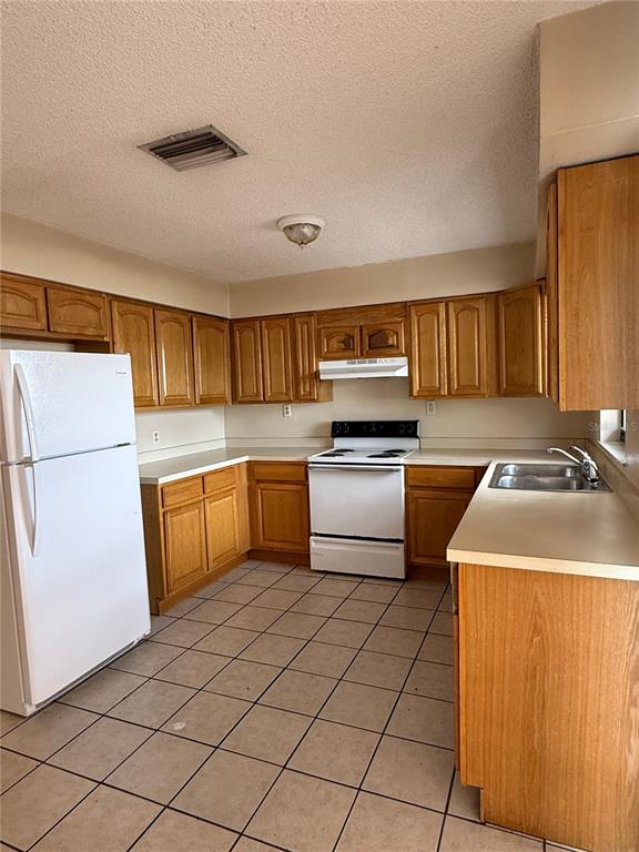 14 Pine Radiel Ocala, FL 34472 - Photo 8 of 10 a kitchen with a sink a stove top oven and refrigerator