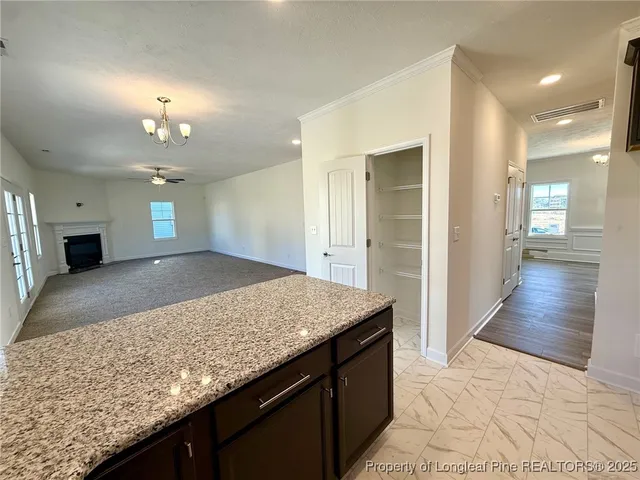 a bathroom with a granite countertop sink a toilet and mirror