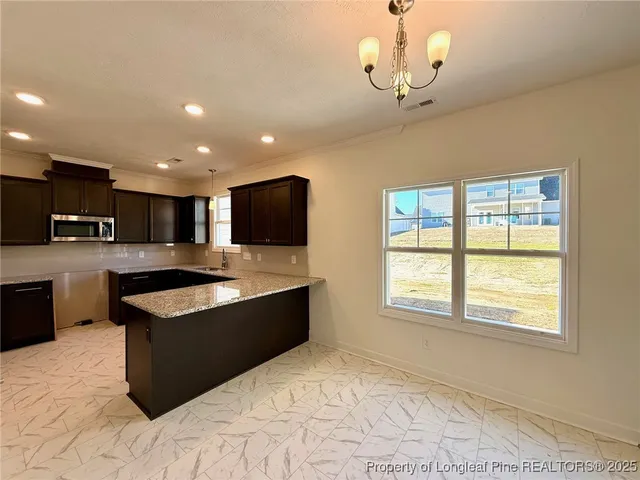 a view of kitchen with sink microwave and refrigerator