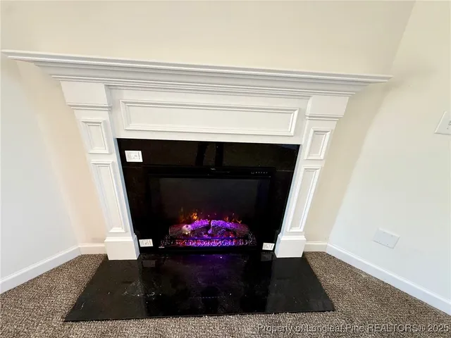 a living room with a fireplace and a window