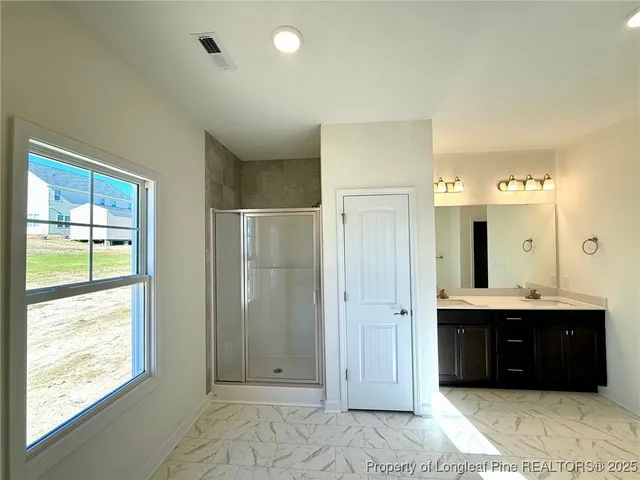 a bathroom with a double vanity sink a mirror and a