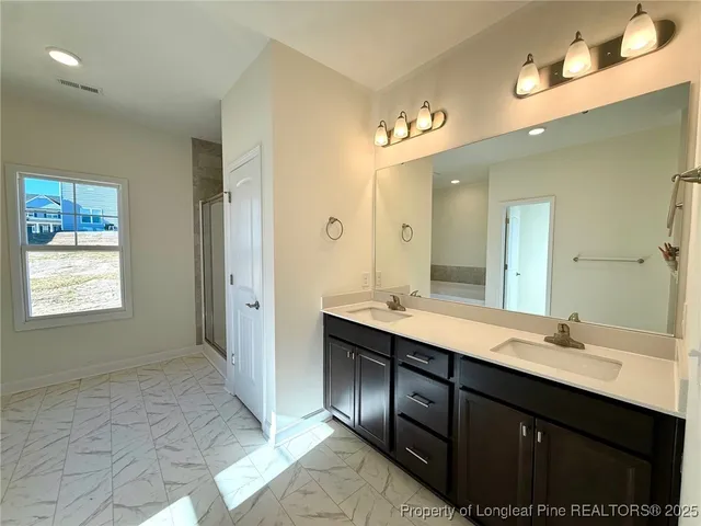 a spacious bathroom with a bathtub and shower