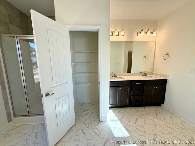 a bathroom with a double vanity sink and a mirror