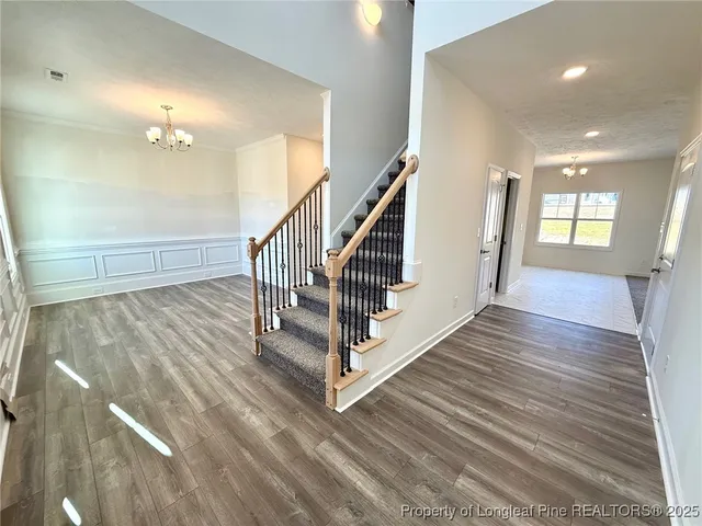 a view of entryway and hall with wooden floor