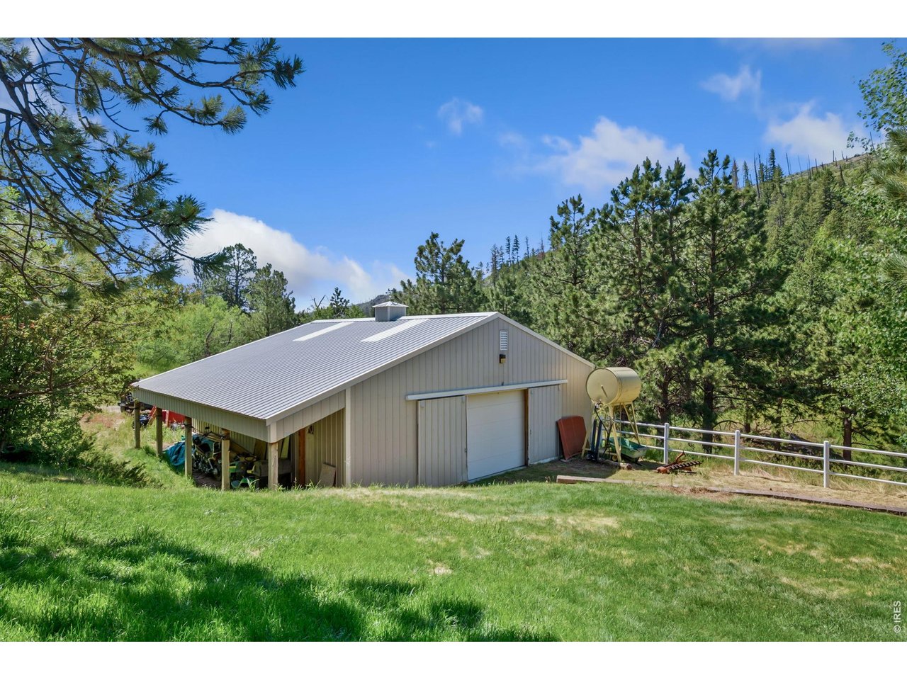 1154 Spring Valley Road Bellvue, CO 80512 - Photo 22 of 31 1,245 sf drive through garage/shop with exterior storage and overhang.