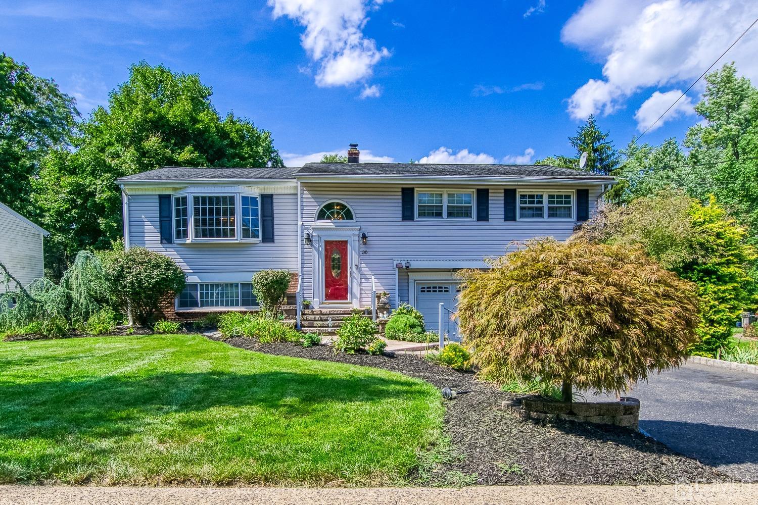 30 Kingsbridge Road Somerset, NJ 08873 - Photo 1 of 23 a front view of a house with a yard
