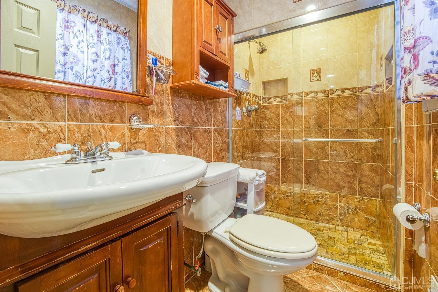 30 Kingsbridge Road Somerset, NJ 08873 - Photo 13 of 23 a bathroom with a sink and a toilet