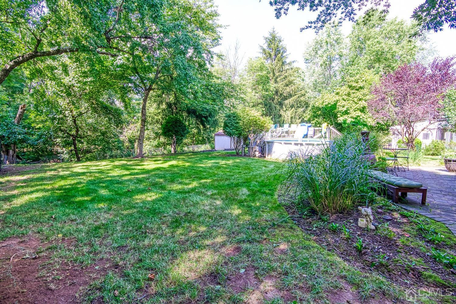 30 Kingsbridge Road Somerset, NJ 08873 - Photo 23 of 23 a backyard of a house with lots of green space and fountain