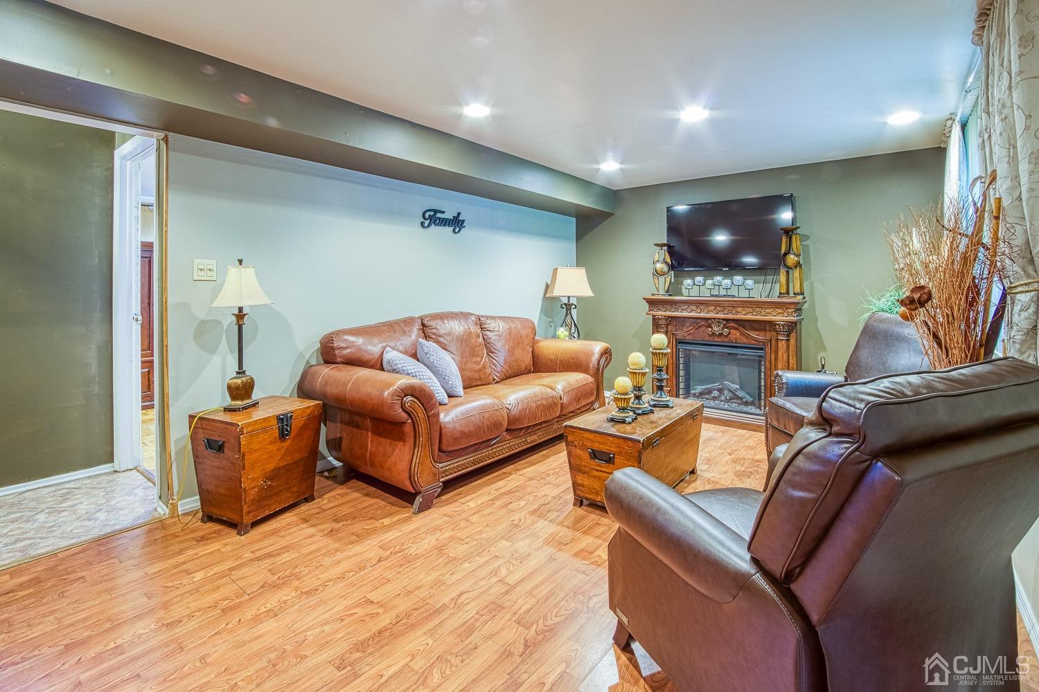 30 Kingsbridge Road Somerset, NJ 08873 - Photo 10 of 23 a living room with furniture a flat screen tv and a wooden floor
