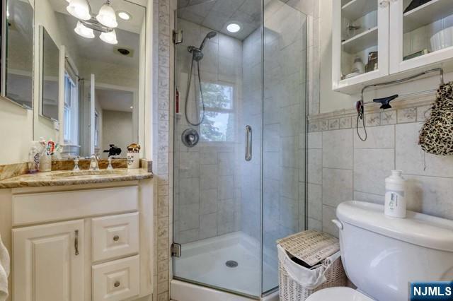 230 Pinelynn Road Glen Rock, NJ 07452 - Photo 11 of 19 a bathroom with a granite countertop sink toilet and shower