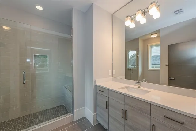 a bathroom with double vanity sink and a mirror