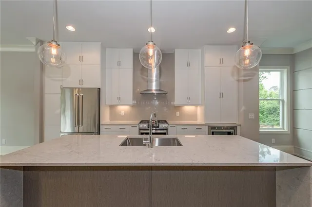 a kitchen with kitchen island granite countertop cabinets and refrigerator
