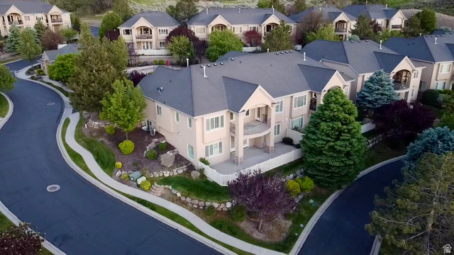 1562 Fairway Ridge Road Draper, UT 84020 - Photo 3 of 60 Stucco exterior residence with a dark gray shingle roof, featuring multiple balconies and mature landscaping