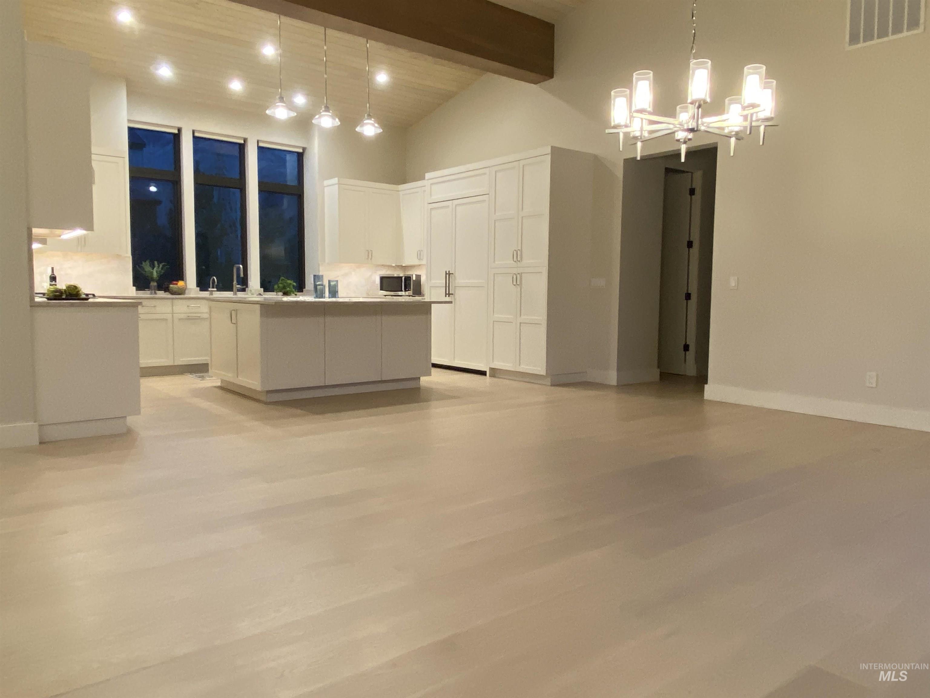 27 Streamside Drive Hailey, ID 83333 - Photo 39 of 39 Kitchen featuring white cabinetry, a kitchen island, light wood-style flooring, light countertops, and open floor plan