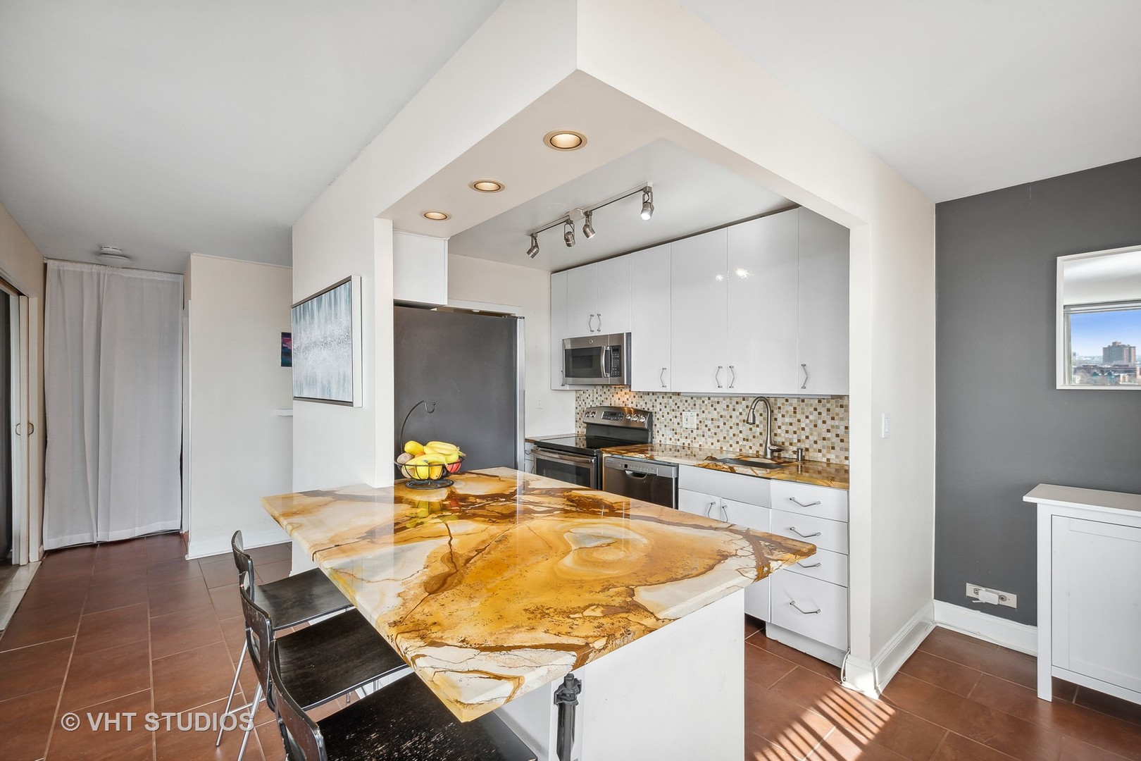 Undisclosed Address Chicago, IL 60610 - Photo 4 of 16 a dining hall with stainless steel appliances kitchen island granite countertop a table chairs and a refrigerator