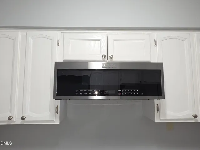 a close view of kitchen countertops with white cabinets