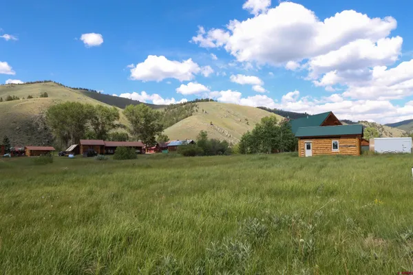 a view of a big house with a big yard