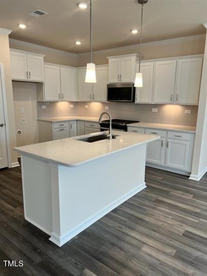 315 Villanova Drive Durham, NC 27713 - Photo 3 of 19 a kitchen with stainless steel appliances granite countertop a sink a stove and a refrigerator