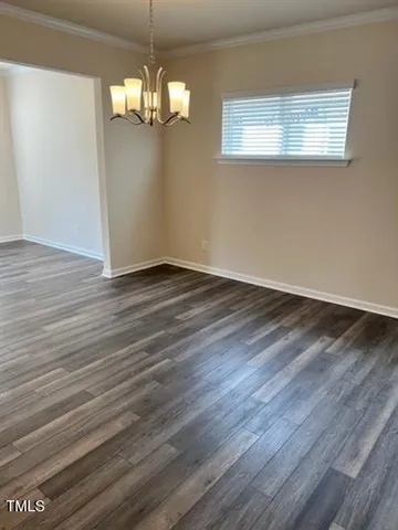 a view of a livingroom with wooden floor and a large window