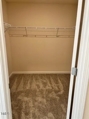 a view of storage and utility room with wooden floor
