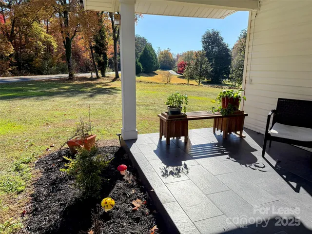 a view of a outdoor kitchen with a table and chairs in the patio
