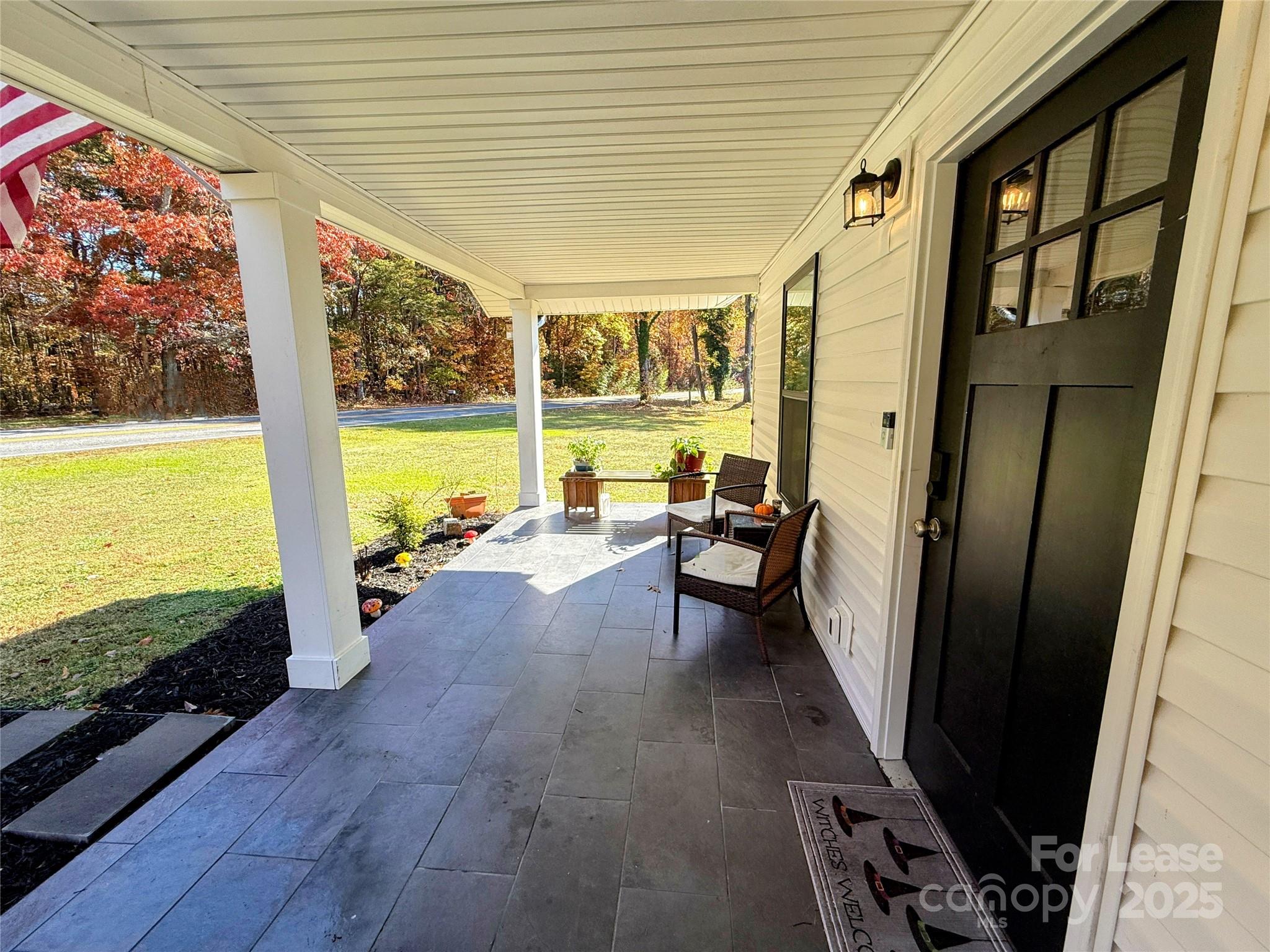 979 Howard Gap Road Tryon, NC 28782 - Photo 3 of 11 a view of a balcony with table and chairs