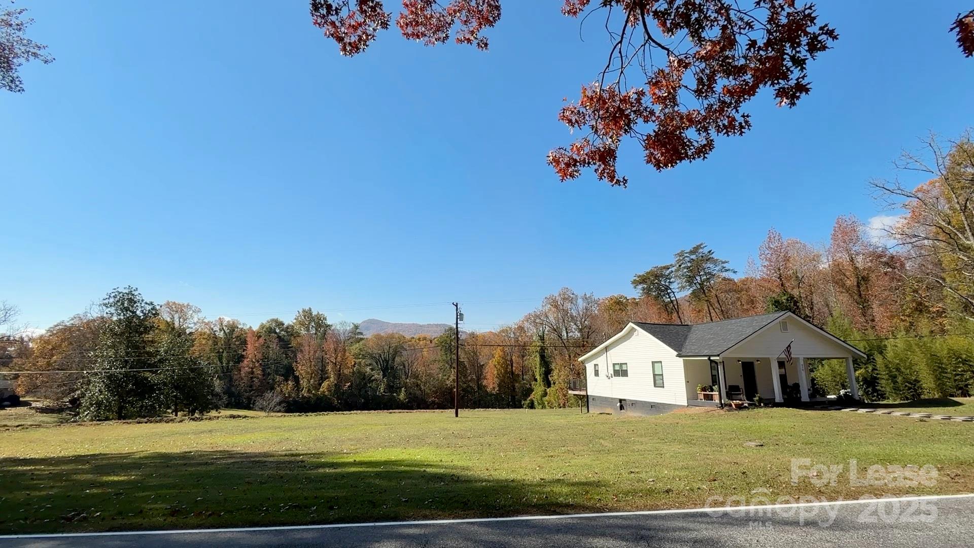 979 Howard Gap Road Tryon, NC 28782 - Photo 5 of 11 a view of a house with a big yard