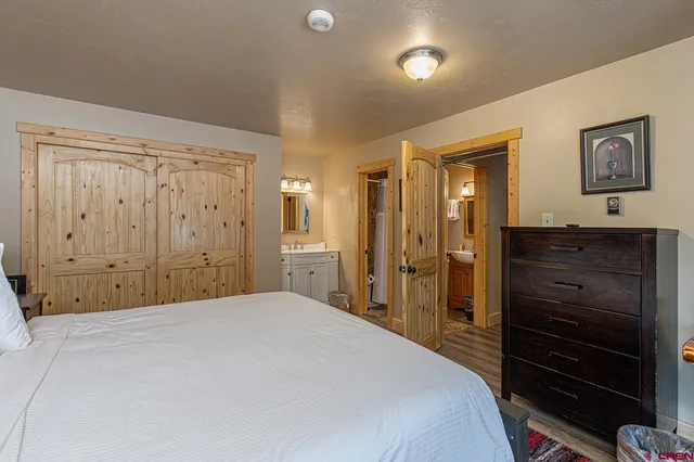 a bedroom with a bed and a dresser