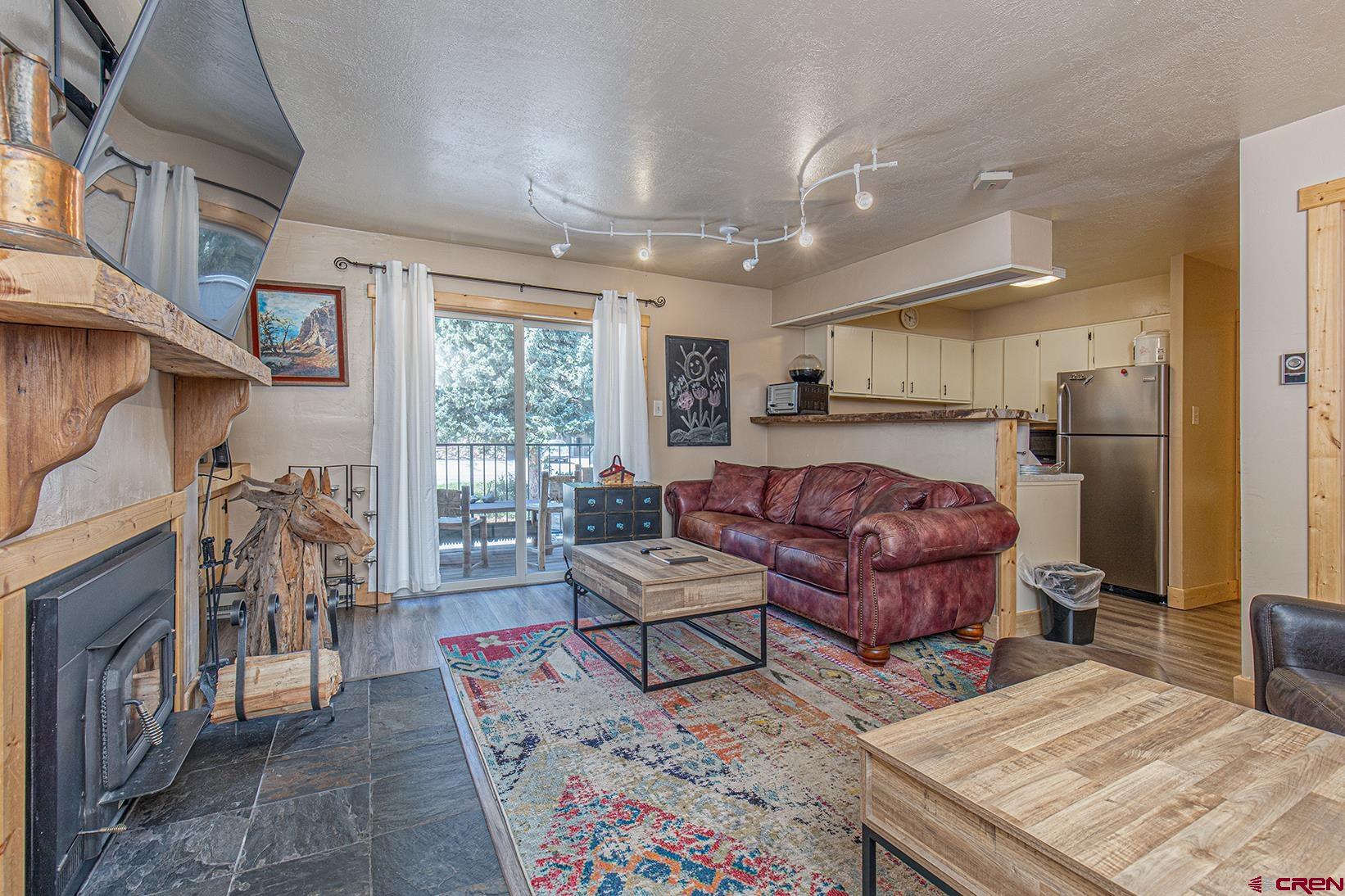395 Sheol Street, Unit 37 Durango, CO 81301 - Photo 4 of 18 a living room with furniture and a large window