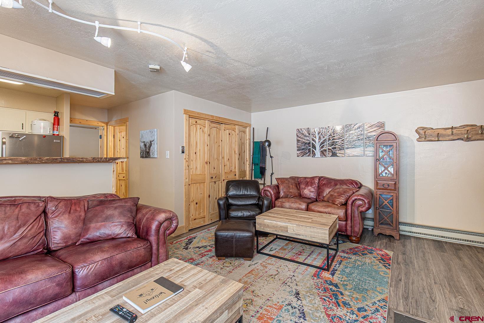 395 Sheol Street, Unit 37 Durango, CO 81301 - Photo 7 of 18 a living room with a couch and a wooden floor