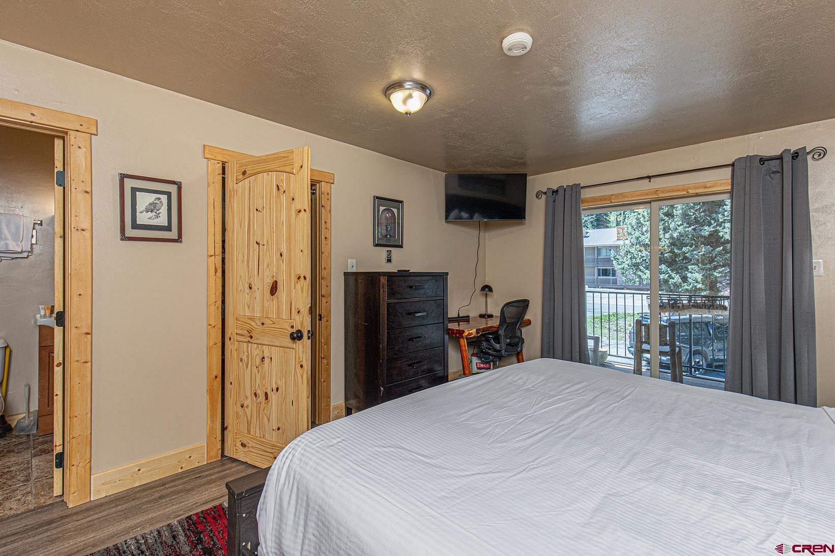 395 Sheol Street, Unit 37 Durango, CO 81301 - Photo 10 of 18 a bedroom with a large bed and a large window
